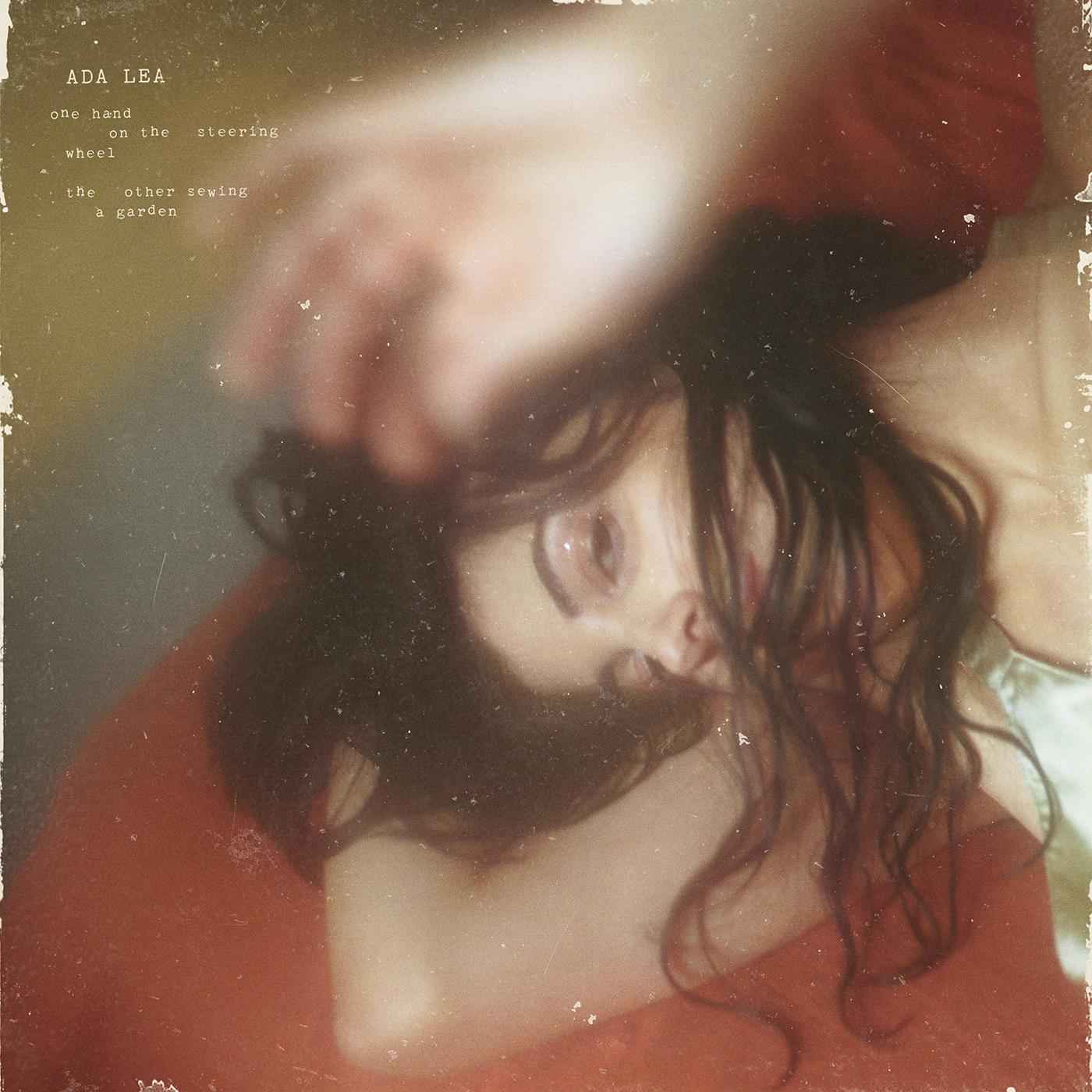 one hand on the steering wheel the other sewing a garden [CD]
